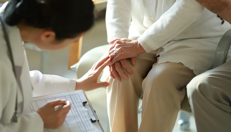 Doctor checking patient’s knee pain