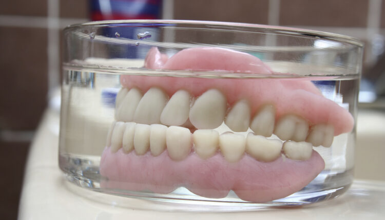 Artificial denture in a glass (front view)